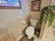 Bathroom featuring toilet, wall art, wooden accents, and neutral walls at 2356 Peavine Cir # 1017, Lakeland, FL 33810