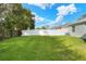 Fenced backyard with lush lawn and mature trees at 3710 Madbury Cir, Lakeland, FL 33810