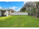 Spacious backyard with grassy area and white fence at 3710 Madbury Cir, Lakeland, FL 33810