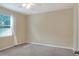 Well-lit bedroom featuring a window with blinds and carpet at 3710 Madbury Cir, Lakeland, FL 33810
