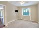 Bedroom with window, carpet, and a view of hallway at 3710 Madbury Cir, Lakeland, FL 33810