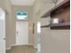 Bright entry hall with tiled floor, neutral walls, and floating shelves at 3710 Madbury Cir, Lakeland, FL 33810