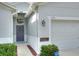 Front entry with gray door, wreath, and adjacent garage at 3710 Madbury Cir, Lakeland, FL 33810