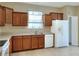 Kitchen with wood cabinets, white appliances, and double sink at 3710 Madbury Cir, Lakeland, FL 33810