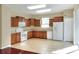 Bright kitchen featuring wood cabinets and white appliances at 3710 Madbury Cir, Lakeland, FL 33810