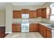 Well-lit kitchen with light wood cabinets and white appliances at 3710 Madbury Cir, Lakeland, FL 33810