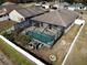 Aerial view of a screened-in pool, patio, and white vinyl fenced yard at 4018 Sundance Place Loop, Mulberry, FL 33860