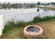 Cozy brick fire pit in the backyard, perfect for outdoor gatherings and relaxation at 4018 Sundance Place Loop, Mulberry, FL 33860