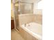 Bathroom featuring a soaking tub with tiled surround and glass-enclosed shower at 4018 Sundance Place Loop, Mulberry, FL 33860