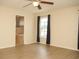 Spacious bedroom featuring neutral paint, ceiling fan and wood-look flooring at 4018 Sundance Place Loop, Mulberry, FL 33860