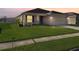 One-story house with a landscaped lawn and attached garage at 4018 Sundance Place Loop, Mulberry, FL 33860