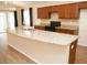 Large island with granite countertops complements the modern cabinets and stainless steel appliances in an open kitchen at 4018 Sundance Place Loop, Mulberry, FL 33860