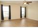 Spacious living room with hardwood floors and ample natural light from dual windows at 4018 Sundance Place Loop, Mulberry, FL 33860