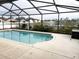 Pool featuring a screened-in enclosure with a view of the lake at 4018 Sundance Place Loop, Mulberry, FL 33860