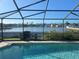 Swimming pool with a screen enclosure and lake view at 4018 Sundance Place Loop, Mulberry, FL 33860