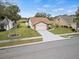 House with a driveway and well-manicured lawn at 4032 Derby Dr, Lakeland, FL 33809