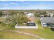 Aerial view of a house with a large backyard, screened enclosure, and white fence at 4032 Derby Dr, Lakeland, FL 33809