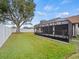 Large backyard with a screened patio and lush green grass at 4032 Derby Dr, Lakeland, FL 33809