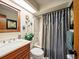 Clean bathroom with tub shower, updated vanity, and decorative accents at 4032 Derby Dr, Lakeland, FL 33809