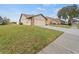 Attached garage with driveway and green lawn at 4032 Derby Dr, Lakeland, FL 33809