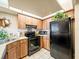 Updated kitchen with black appliances and wood cabinets at 4032 Derby Dr, Lakeland, FL 33809