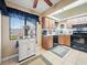 Kitchen features wood cabinets, black appliances, and a breakfast bar at 4032 Derby Dr, Lakeland, FL 33809