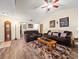 Living room with vaulted ceiling, hardwood floors, and brown couches at 4032 Derby Dr, Lakeland, FL 33809