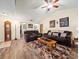 Living room with vaulted ceiling, hardwood floors, and brown couches at 4032 Derby Dr, Lakeland, FL 33809