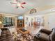 Living area with hardwood floors, comfortable seating, and access to a sunroom at 4032 Derby Dr, Lakeland, FL 33809