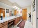 Primary bathroom with double vanity and wood cabinets at 4032 Derby Dr, Lakeland, FL 33809