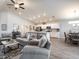 Open-concept living room with gray sofas and a view into the kitchen at 4479 Rapallo Ave, Winter Haven, FL 33884
