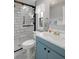 Updated bathroom with subway tile shower and blue vanity at 5079 Lodgewood Dr, Lakeland, FL 33810
