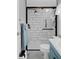Modern bathroom with a shower and blue vanity at 5079 Lodgewood Dr, Lakeland, FL 33810