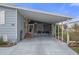 Covered carport with seating area next to the home entrance at 5079 Lodgewood Dr, Lakeland, FL 33810