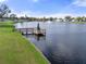 Wooden dock on a lake with a small Christmas tree at 5079 Lodgewood Dr, Lakeland, FL 33810