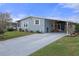 Mobile home with covered carport and inviting yellow door at 5079 Lodgewood Dr, Lakeland, FL 33810