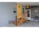Inviting yellow front door with wooden steps and festive decor at 5079 Lodgewood Dr, Lakeland, FL 33810