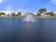 Scenic lake view with fountain in a residential community at 5079 Lodgewood Dr, Lakeland, FL 33810