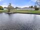 Peaceful lakefront view with a dock and community building at 5079 Lodgewood Dr, Lakeland, FL 33810