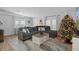 Open-concept living area with a large sectional sofa and Christmas tree at 5079 Lodgewood Dr, Lakeland, FL 33810