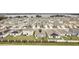 Community overview with lake view and many homes with solar panels at 636 Trotters Dr, Eagle Lake, FL 33839