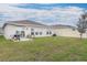Private backyard with patio, grill, and grassy area at 636 Trotters Dr, Eagle Lake, FL 33839