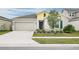 House exterior featuring a two-car garage and well-maintained lawn at 636 Trotters Dr, Eagle Lake, FL 33839