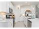 Modern kitchen with white cabinets, stainless steel appliances, and an island at 636 Trotters Dr, Eagle Lake, FL 33839