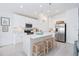 Modern kitchen with white cabinets, stainless steel appliances, and an island at 636 Trotters Dr, Eagle Lake, FL 33839