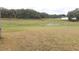 Large backyard with grassy area and distant view of homes at 6759 Ashbury Dr, Lakeland, FL 33809