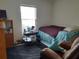 Cozy bedroom featuring a full-size bed and a window offering natural light at 6759 Ashbury Dr, Lakeland, FL 33809