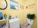 Bright bathroom with toilet, sink, and cheerful decor at 6929 Farris Dr, Lakeland, FL 33811
