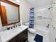 Updated bathroom features a white quartz vanity, marble tile shower/tub combo, and stylish fixtures at 6929 Farris Dr, Lakeland, FL 33811