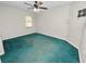 Spacious bedroom with teal carpet and ceiling fan at 6929 Farris Dr, Lakeland, FL 33811